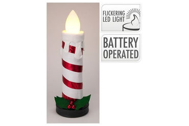 Battery-operated LED candle with candy cane design on a beige background